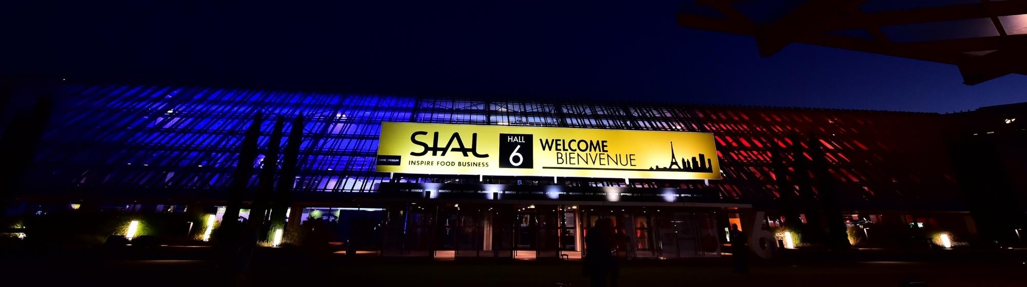 Illuminated entrance of Hall 6 at SIAL Paris, welcoming visitors with a 'Welcome - Bienvenue' sign