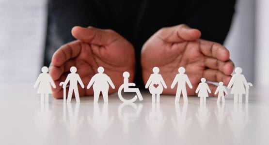 Symbols representing diverse inclusive silhouettes: wheelchair users, children, adults, and seniors, protected by hands in the background.